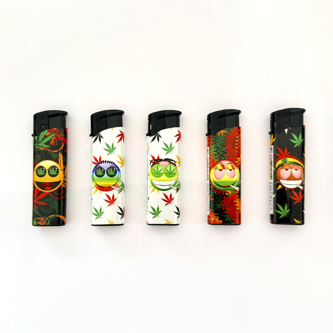 Row of five disposable lighters with cannabis leaf patterns and grinning emoji faces in various colors.