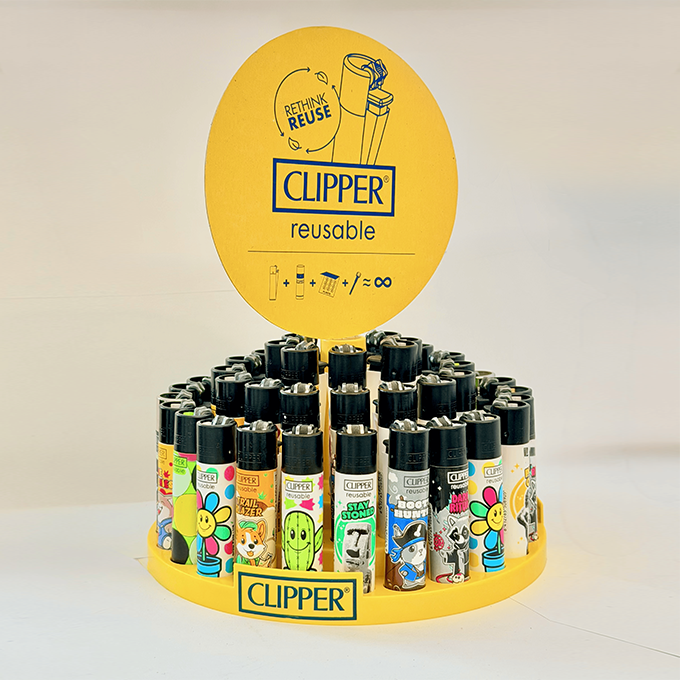 Yellow round promotional display of Clipper reusable lighters with colorful designs arranged in a circle for advertising purposes