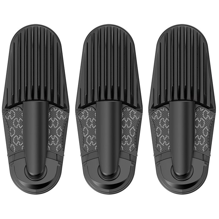 Three black hair brushes lined up side by side with ribbed bristle heads facing up.
